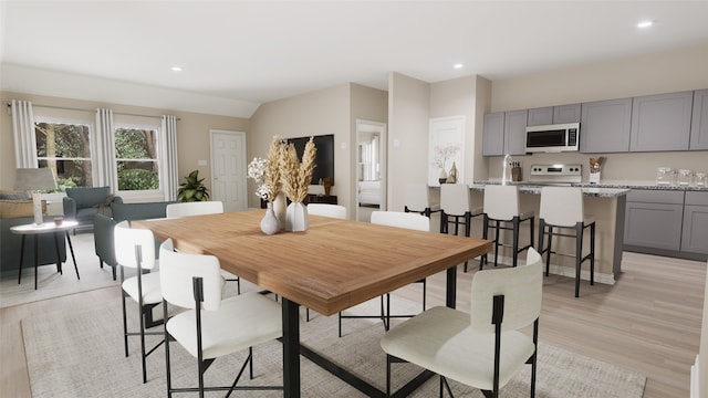 dining room with light hardwood / wood-style flooring and sink