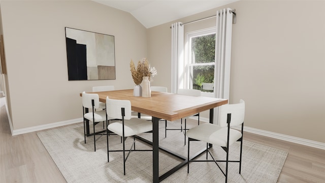 dining space featuring light hardwood / wood-style flooring and lofted ceiling