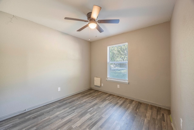 spare room with ceiling fan and wood-type flooring