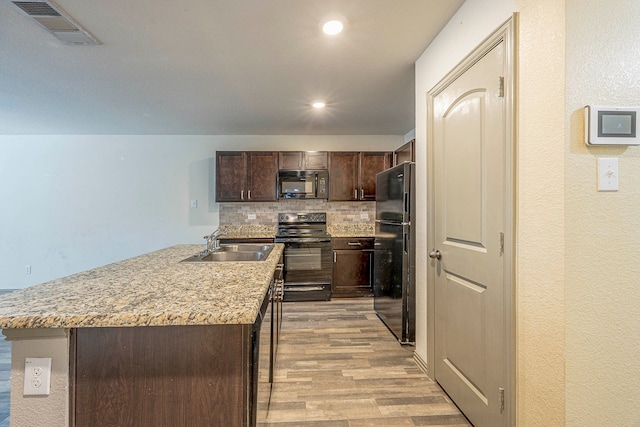 kitchen featuring backsplash, dark brown cabinets, sink, black appliances, and light hardwood / wood-style flooring