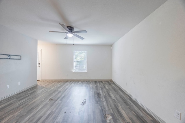 unfurnished room with ceiling fan and dark hardwood / wood-style floors