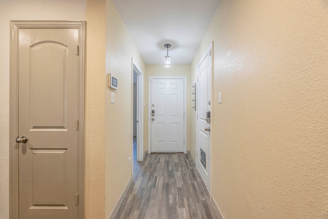 corridor featuring dark hardwood / wood-style flooring