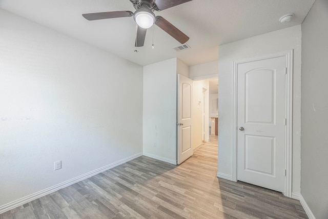 unfurnished bedroom with ceiling fan and wood-type flooring