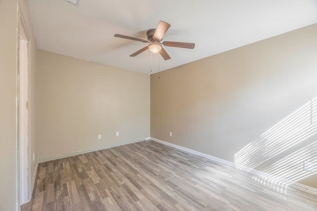 empty room featuring ceiling fan and hardwood / wood-style flooring