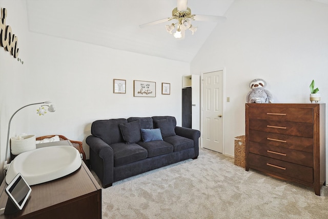 carpeted living room with high vaulted ceiling and ceiling fan