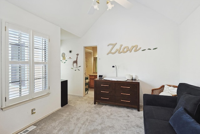 living area featuring high vaulted ceiling and light carpet