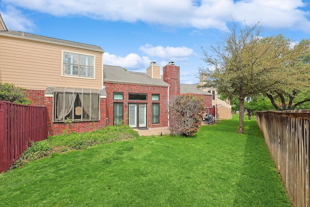 back of property featuring a lawn