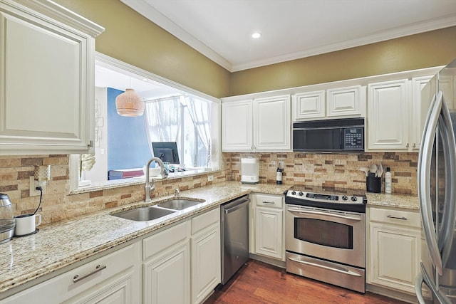 kitchen featuring sink, crown molding, appliances with stainless steel finishes, decorative backsplash, and white cabinets