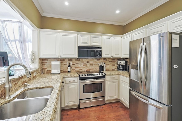 kitchen featuring white cabinetry, sink, light stone counters, and stainless steel appliances