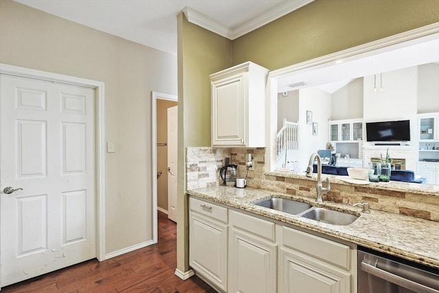 kitchen with tasteful backsplash, sink, stainless steel dishwasher, and light stone counters