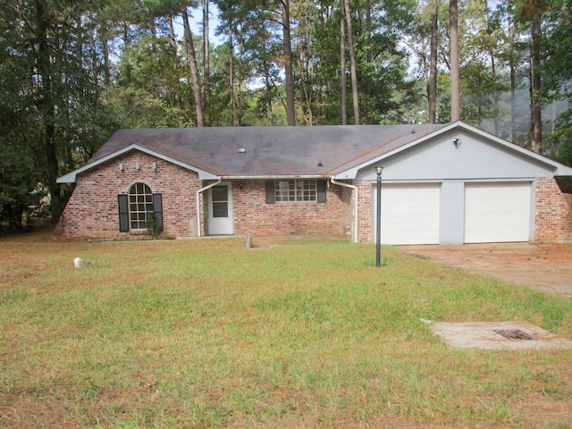 ranch-style home with a front yard and a garage