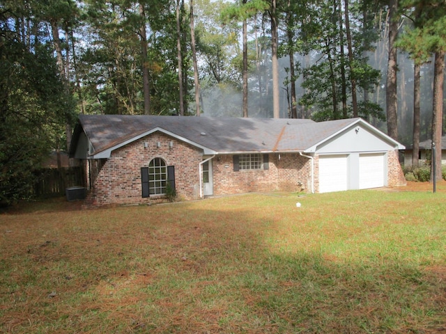 ranch-style house with central AC unit, a garage, and a front yard