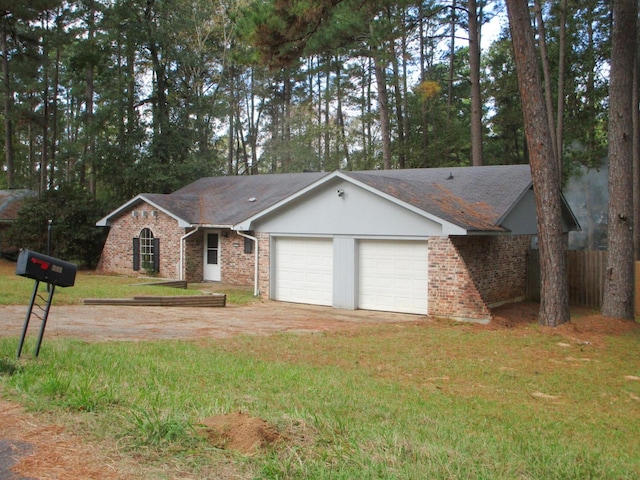 ranch-style home with a garage and a front lawn