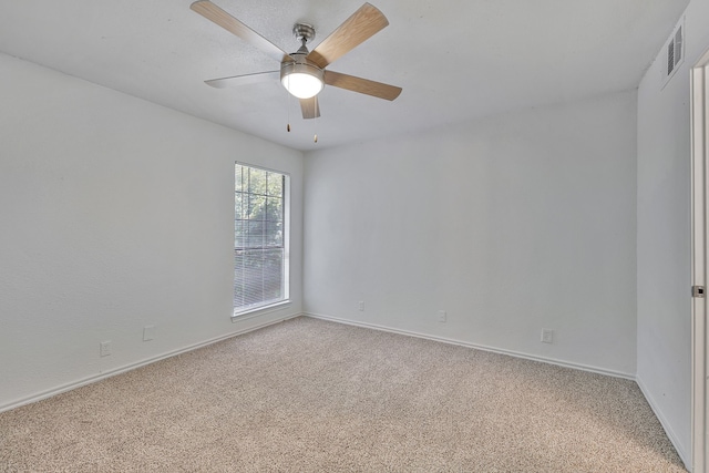 empty room with ceiling fan and light colored carpet