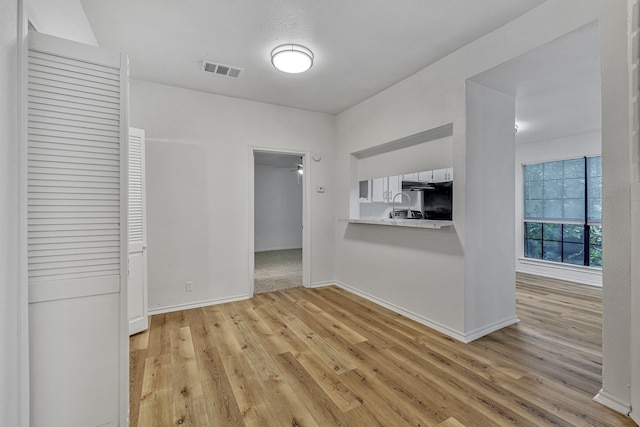 unfurnished living room with light hardwood / wood-style floors