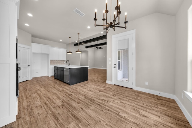 kitchen with dishwasher, white cabinets, hanging light fixtures, a kitchen island with sink, and light wood-type flooring