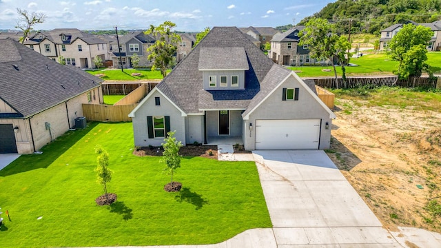 view of front of house with a garage, central air condition unit, and a front lawn