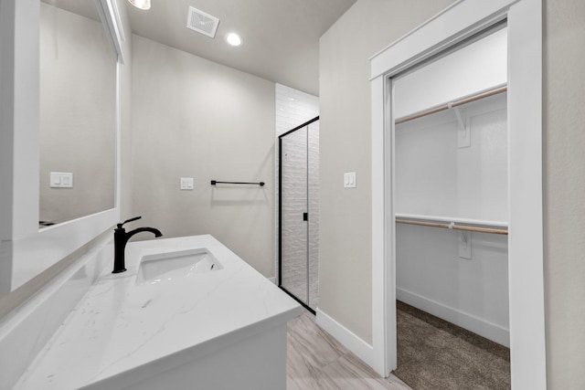 bathroom with an enclosed shower and vanity