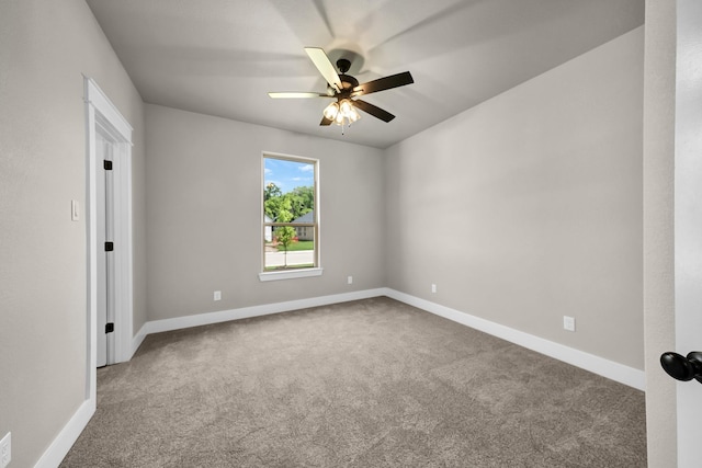 carpeted spare room featuring ceiling fan