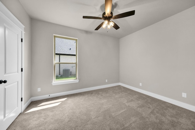 spare room featuring light colored carpet and ceiling fan