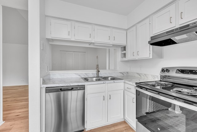 kitchen with light stone counters, stainless steel appliances, sink, light hardwood / wood-style flooring, and white cabinets