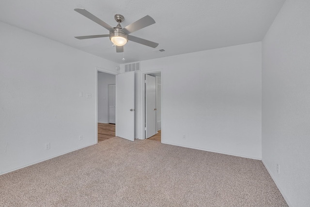 unfurnished room featuring light colored carpet and ceiling fan