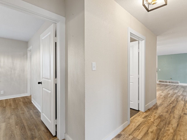 corridor featuring hardwood / wood-style flooring