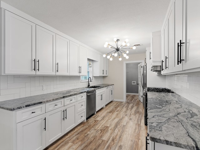 kitchen featuring stone counters, light hardwood / wood-style flooring, white cabinets, and stainless steel appliances