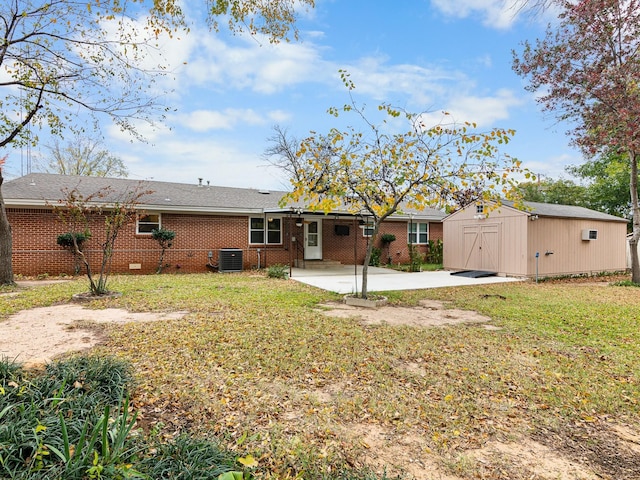 back of property featuring central AC, a shed, a patio, and a lawn