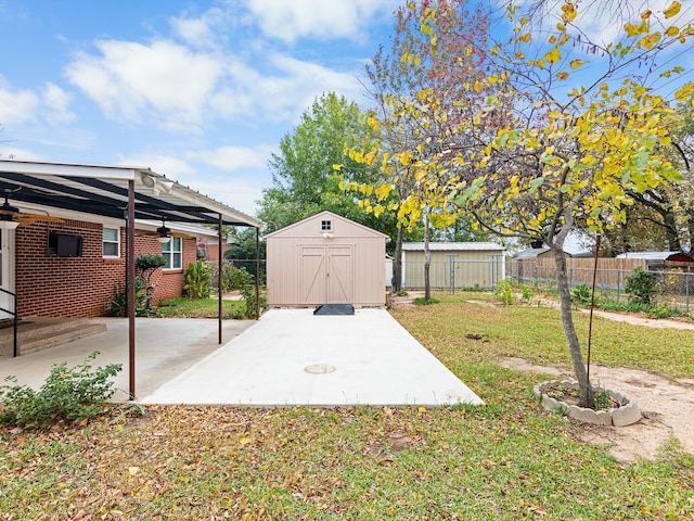 view of yard featuring a shed and a patio area