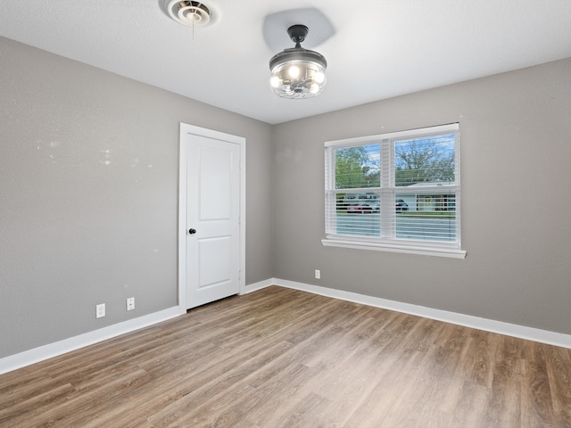 spare room featuring hardwood / wood-style flooring