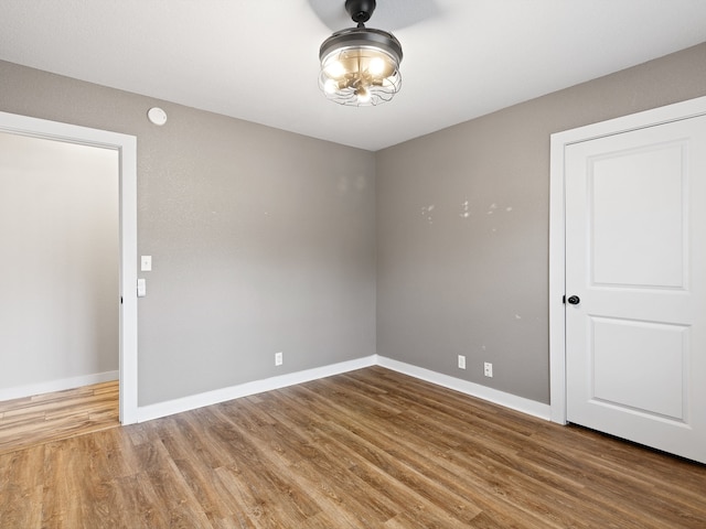 unfurnished room with wood-type flooring