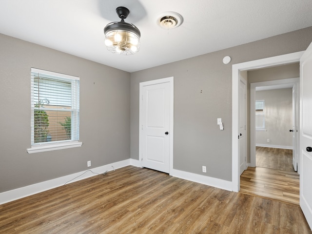 empty room with hardwood / wood-style floors