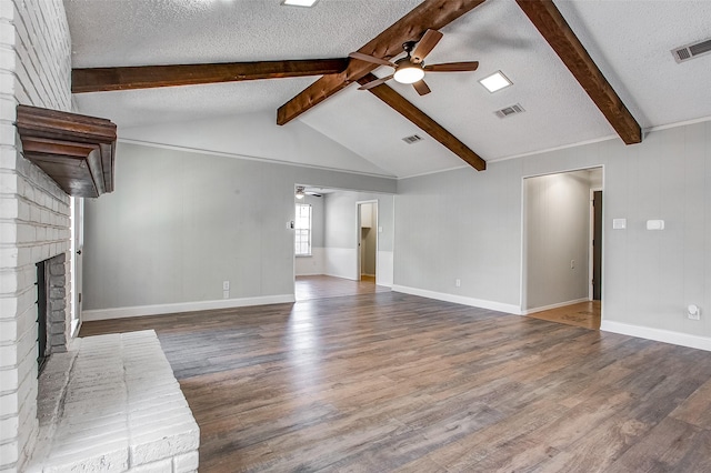 unfurnished living room with hardwood / wood-style floors, ceiling fan, vaulted ceiling with beams, and a fireplace