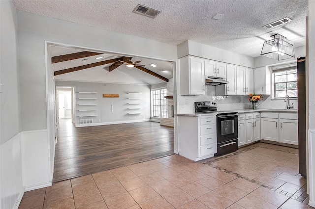 kitchen featuring white cabinets, lofted ceiling with beams, ceiling fan, light wood-type flooring, and black / electric stove