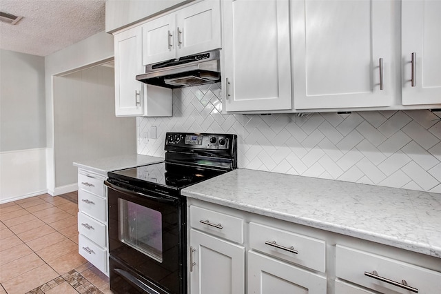 kitchen featuring tasteful backsplash, white cabinetry, light tile patterned floors, and black electric range