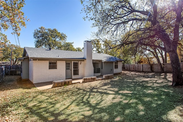 back of house with a yard and a patio area