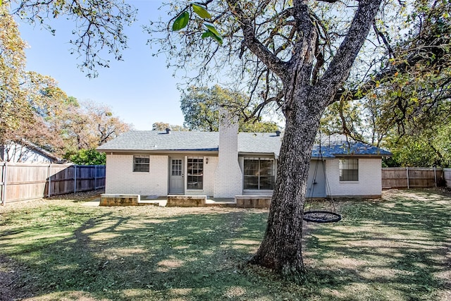 back of property featuring a lawn