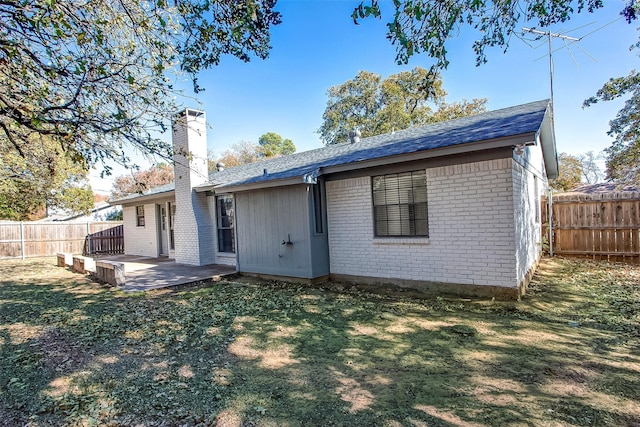 rear view of house featuring a lawn and a patio area