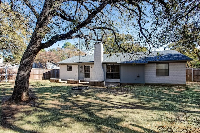 back of property featuring a yard