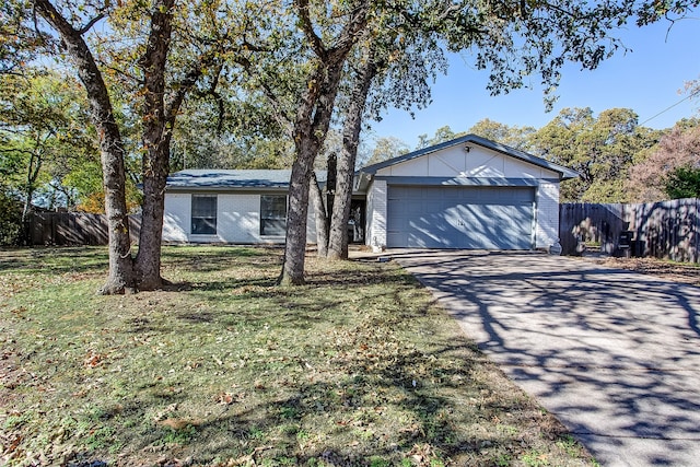 ranch-style home with a front yard and a garage