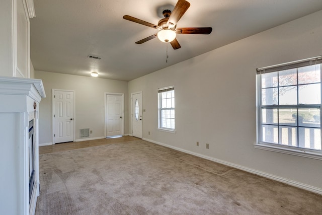 interior space featuring ceiling fan and light colored carpet