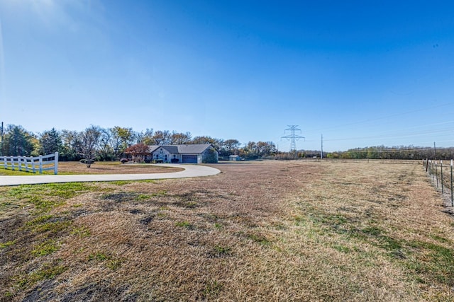 view of yard with a rural view