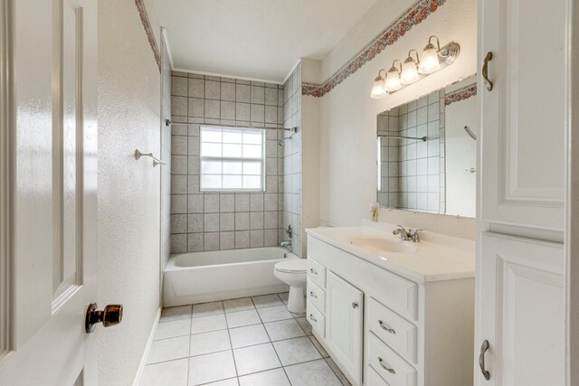 full bathroom with vanity, tile patterned flooring, tiled shower / bath, and toilet