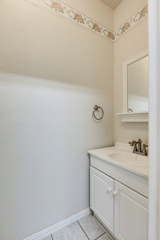 bathroom featuring tile patterned flooring and vanity