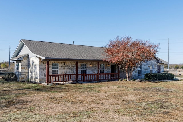 single story home featuring covered porch and a front lawn