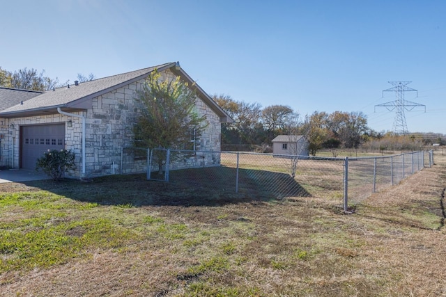 view of side of home featuring a lawn and a garage