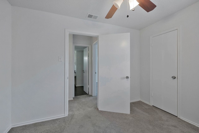 unfurnished bedroom featuring light colored carpet and ceiling fan