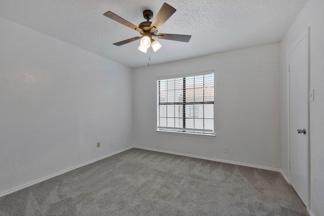 carpeted empty room featuring ceiling fan and a textured ceiling