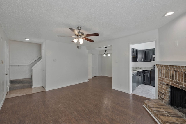 unfurnished living room with dark hardwood / wood-style flooring and a textured ceiling